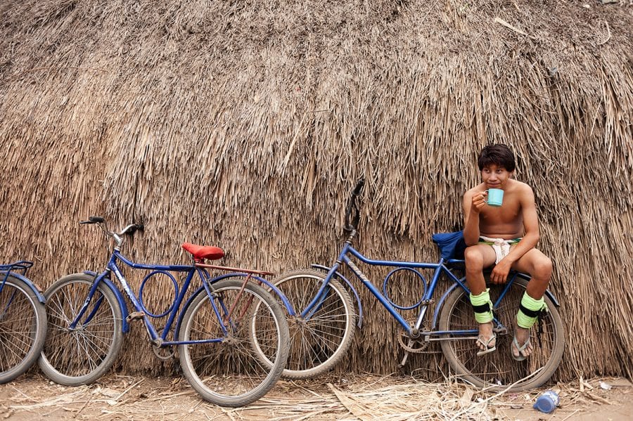 Indigenous man sat on a bike
