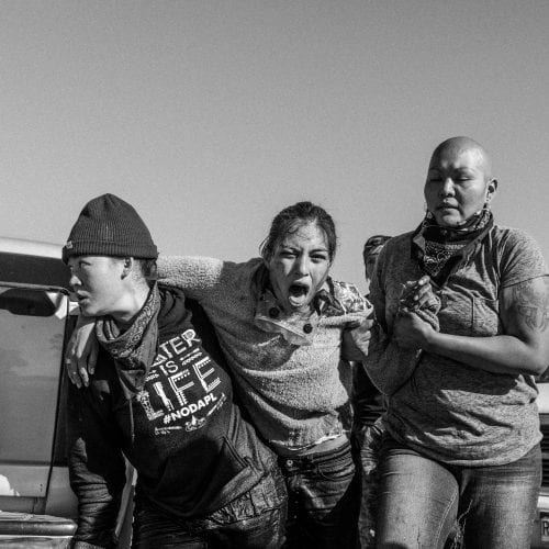 A group of women carry a wounded warrior