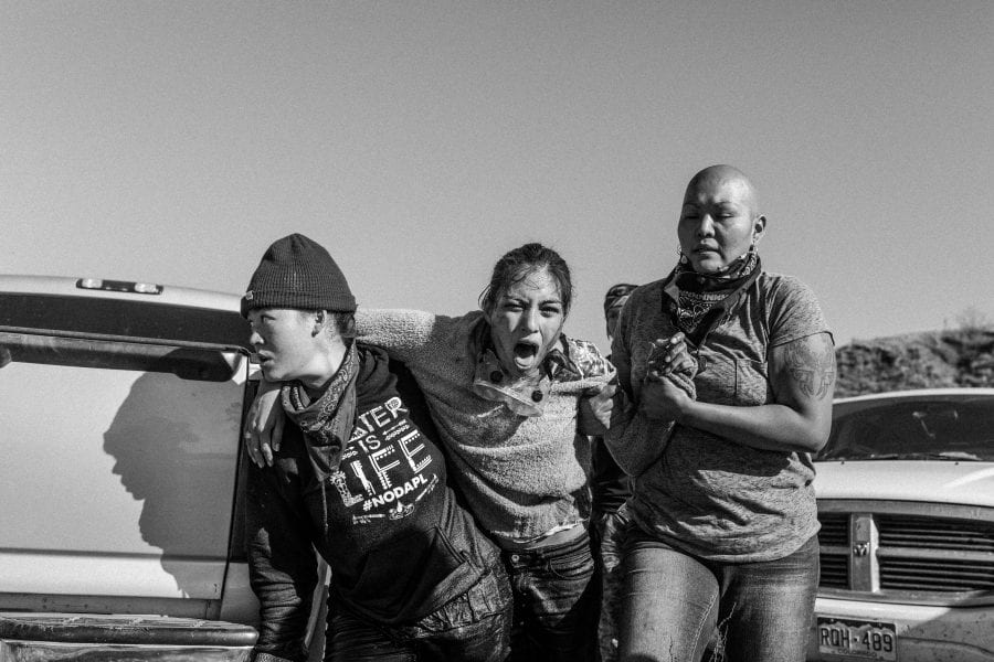 A group of women carry a wounded warrior